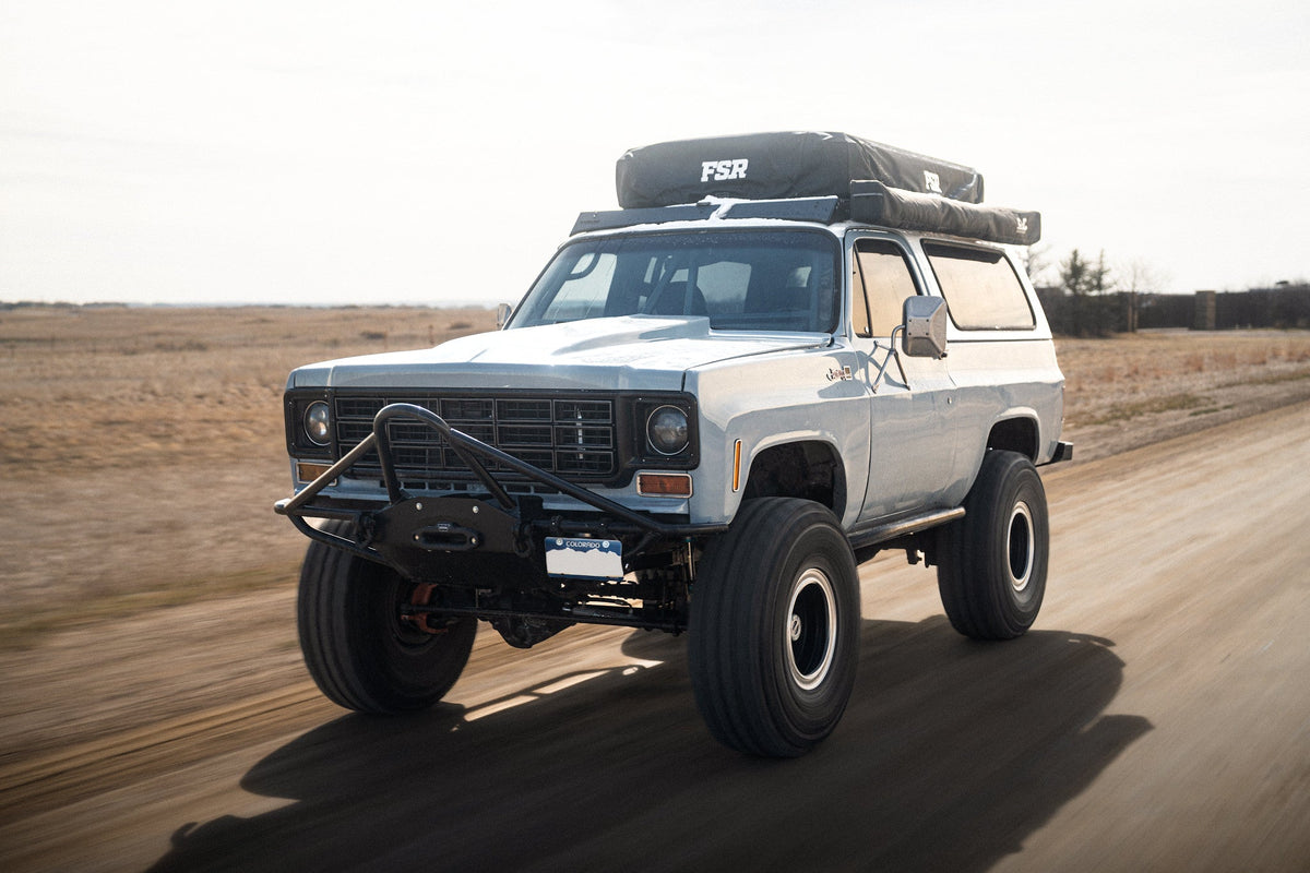 Vehicle driving with rooftop tent and awning